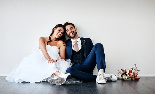 Studio Shot of a Newly Married Young Couple Sitting Together