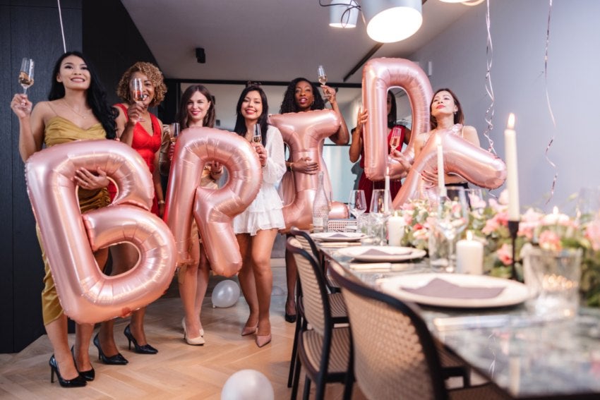 Female Friends Posing with Bride Balloons at a Bachelorette Party